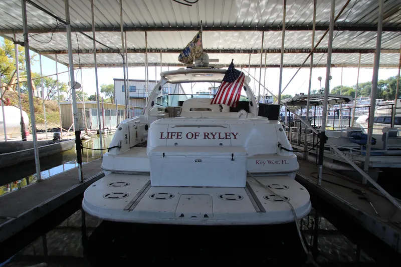 Slide: The Image of 2001 Sea Ray 460 Sundancer yacht docked, rear view with American flag. - 4