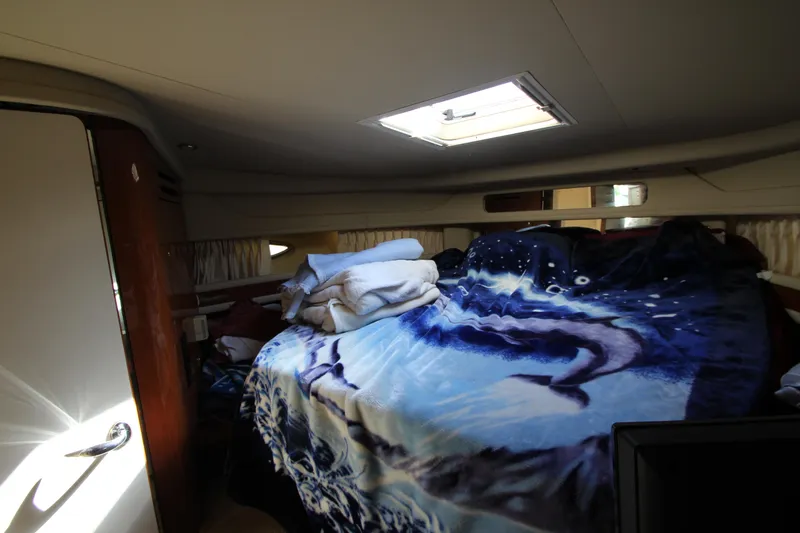 Slide: The Image of Cozy cabin interior of 2001 Sea Ray 460 Sundancer with skylight and patterned bedding. - 43