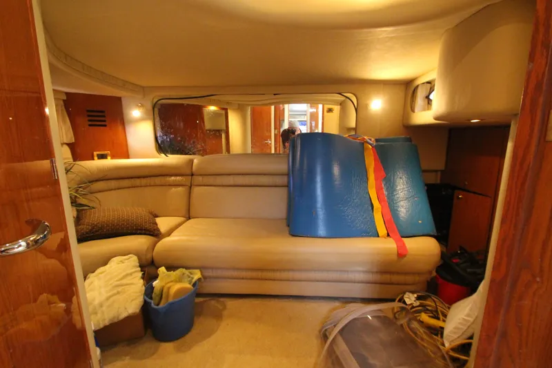 Slide: The Image of Interior of 2001 Sea Ray 460 Sundancer yacht with beige seating and storage items. - 46