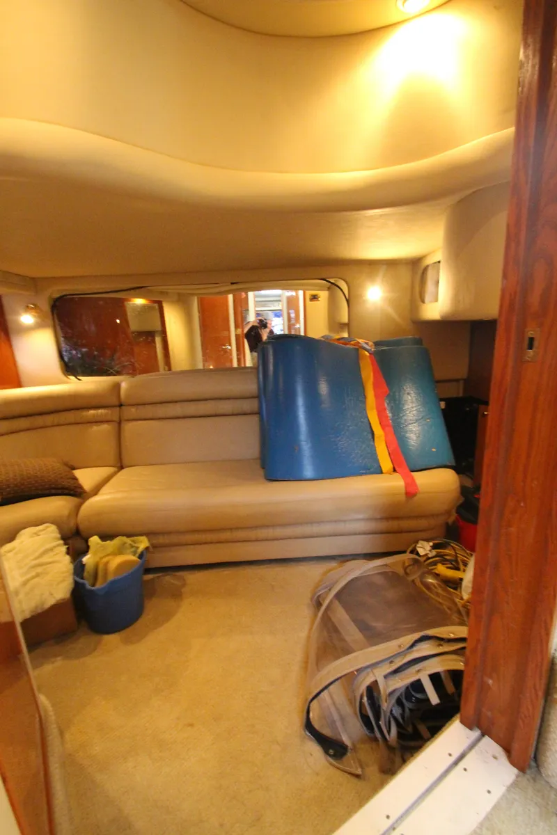 Slide: The Image of Interior of 2001 Sea Ray 460 Sundancer yacht with beige seating and nautical equipment. - 47
