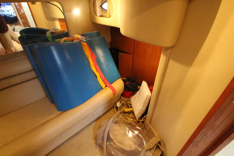 Slide: The Image of Interior of 2001 Sea Ray 460 Sundancer with storage area and blue mats. - 49