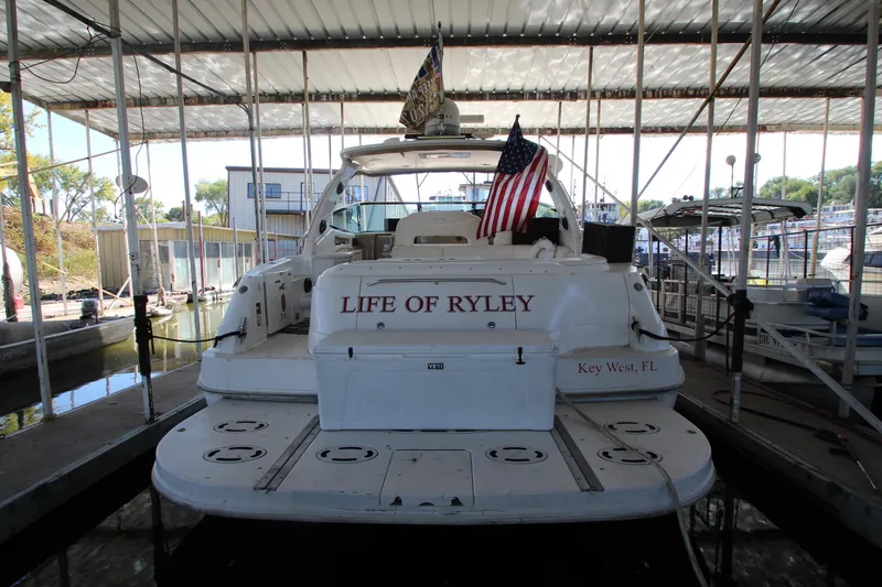 Slide: The Image of 2001 Sea Ray 460 Sundancer docked, named "Life of Ryley," with American flag. - 5