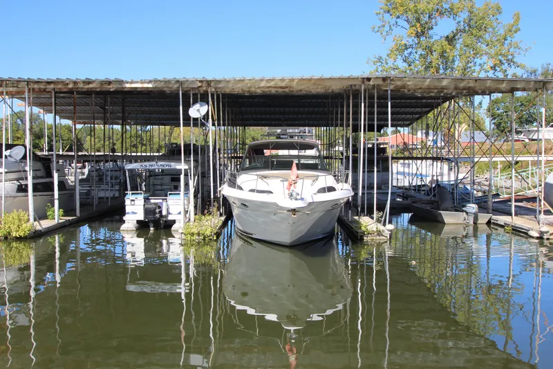 Slide: The Image of 2001 Sea Ray 460 Sundancer docked in a marina under a covered slip. - 6