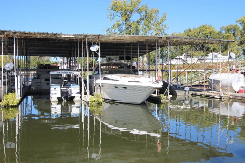 Slide: The Image of 2001 Sea Ray 460 Sundancer docked in a marina under a covered shelter. - 8