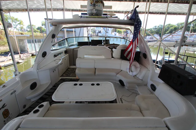Slide: The Image of Interior of 2001 Sea Ray 460 Sundancer yacht with seating and American flag. - 9