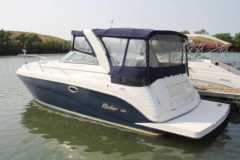 The Image of 2005 Rinker 312 Fiesta Vee boat docked on calm water. - 0