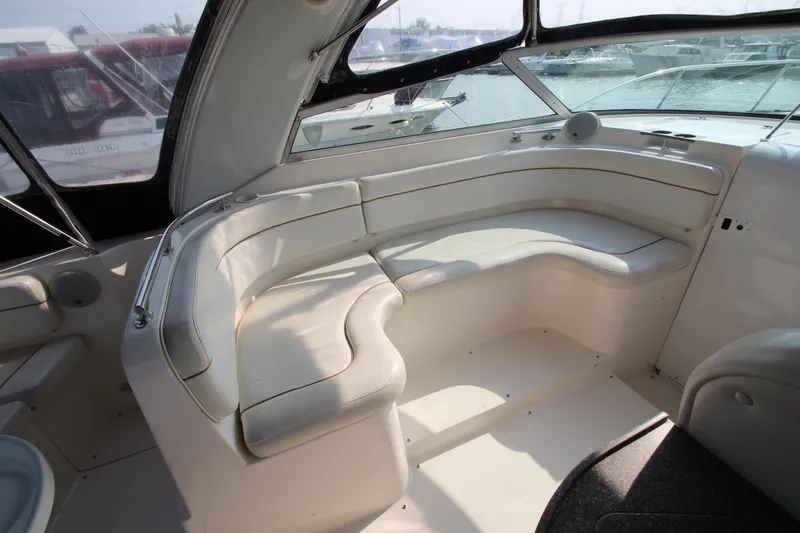 Slide: The Image of 2005 Rinker 312 Fiesta Vee boat interior with white seating and windows. - 11