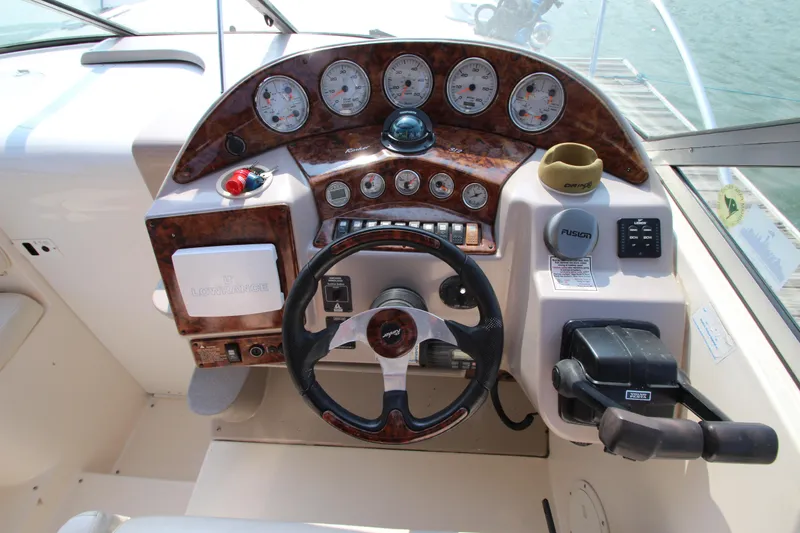 Slide: The Image of 2005 Rinker 312 Fiesta Vee boat dashboard with steering wheel and control panel. - 12