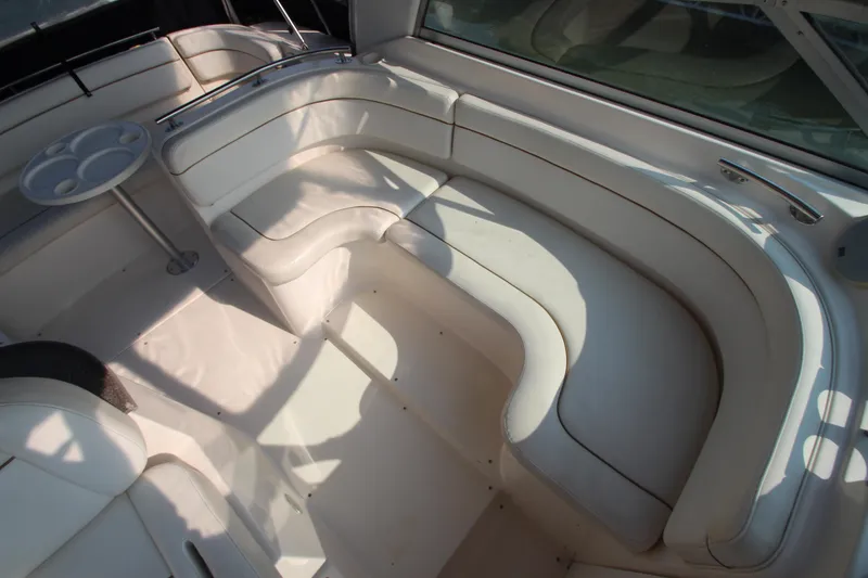 Slide: The Image of 2005 Rinker 312 Fiesta Vee boat interior with white leather seating. - 14