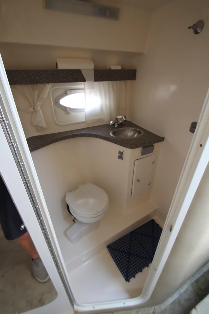 Slide: The Image of 2005 Rinker 312 Fiesta Vee boat bathroom with sink and toilet. - 17