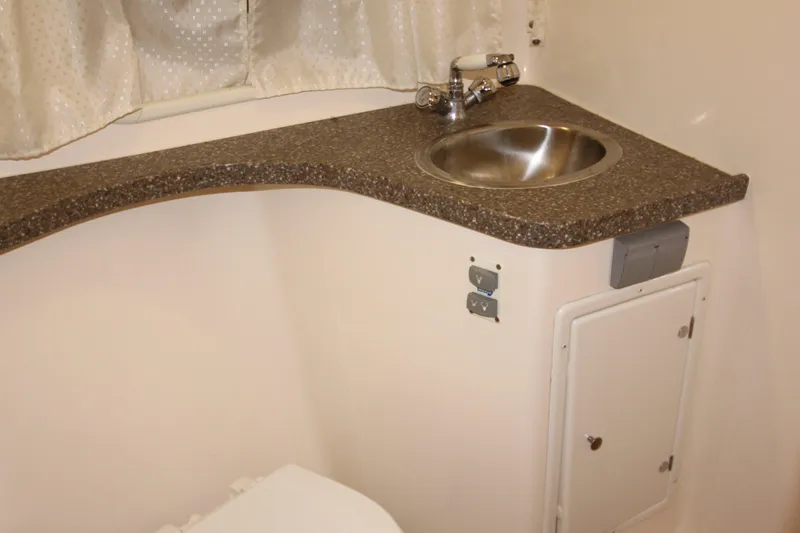 Slide: The Image of 2005 Rinker 312 Fiesta Vee bathroom sink and countertop. - 18