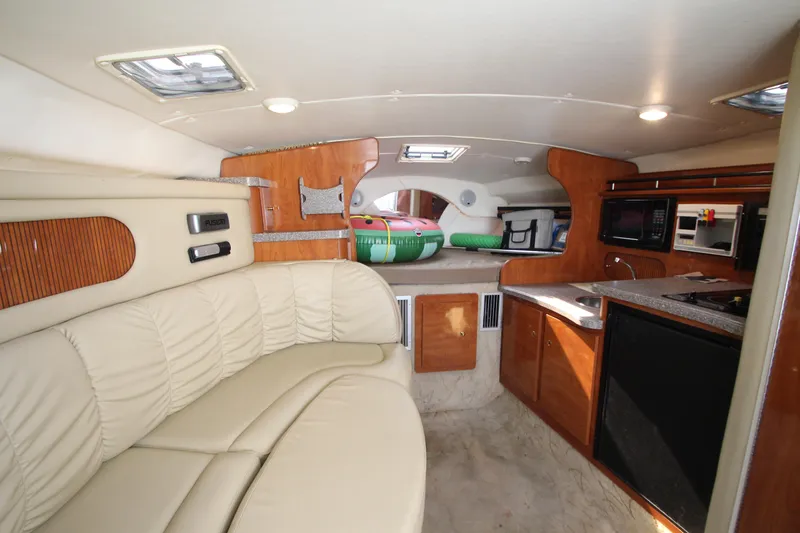 Slide: The Image of 2005 Rinker 312 Fiesta Vee cabin interior with kitchenette and seating area. - 23