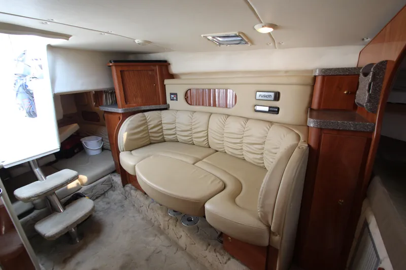 Slide: The Image of Interior of 2005 Rinker 312 Fiesta Vee boat with beige leather seating. - 24