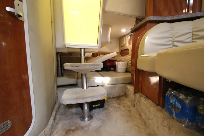 Slide: The Image of Interior cabin of a 2005 Rinker 312 Fiesta Vee boat with steps and seating area. - 25