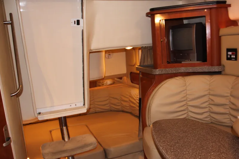 Slide: The Image of Interior cabin of a 2005 Rinker 312 Fiesta Vee boat with seating and TV. - 26