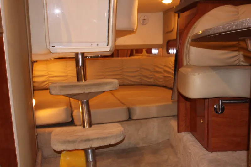 Slide: The Image of Interior cabin of 2005 Rinker 312 Fiesta Vee with beige seating and wooden accents. - 27