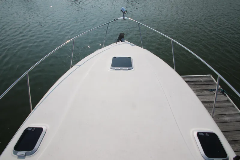 Slide: The Image of 2005 Rinker 312 Fiesta Vee boat bow view at dock. - 3