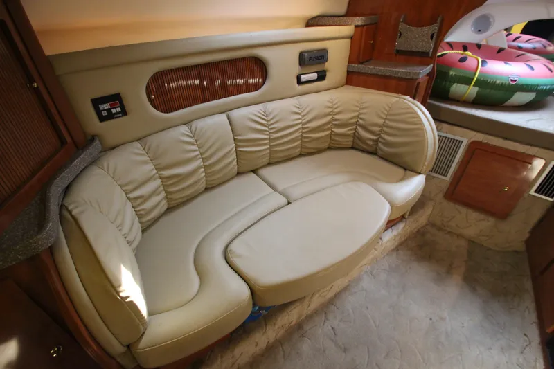 Slide: The Image of 2005 Rinker 312 Fiesta Vee cabin with beige leather seating and wooden accents. - 31