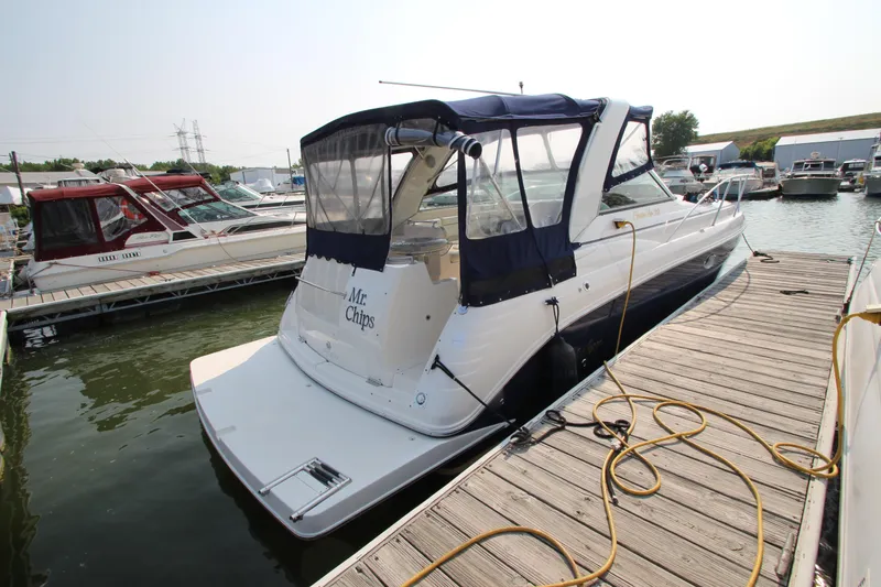 Slide: The Image of 2005 Rinker 312 Fiesta Vee docked at a marina. - 5