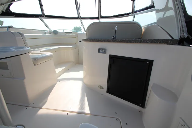 Slide: The Image of 2005 Rinker 312 Fiesta Vee boat interior with seating and kitchenette. - 8