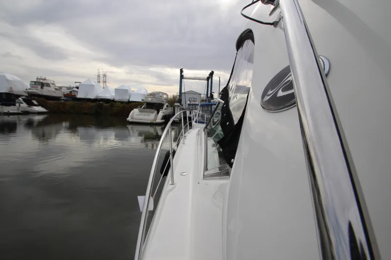 Slide: The Image of 2007 Sea Ray 44 Sundancer yacht docked in a marina, overcast sky. - 14