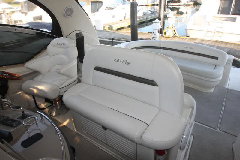 Slide: The Image of 2007 Sea Ray 44 Sundancer interior with white leather seating and helm station. - 26