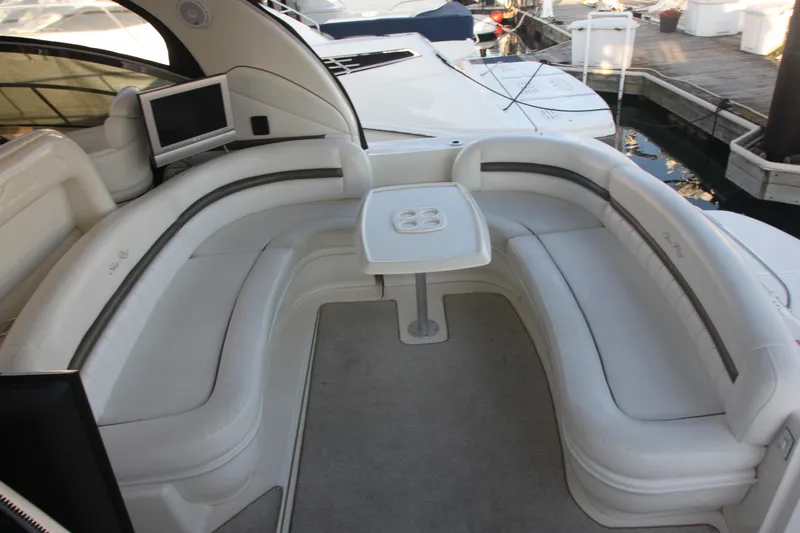 Slide: The Image of 2007 Sea Ray 44 Sundancer yacht with spacious white seating and table in the cockpit area. - 27