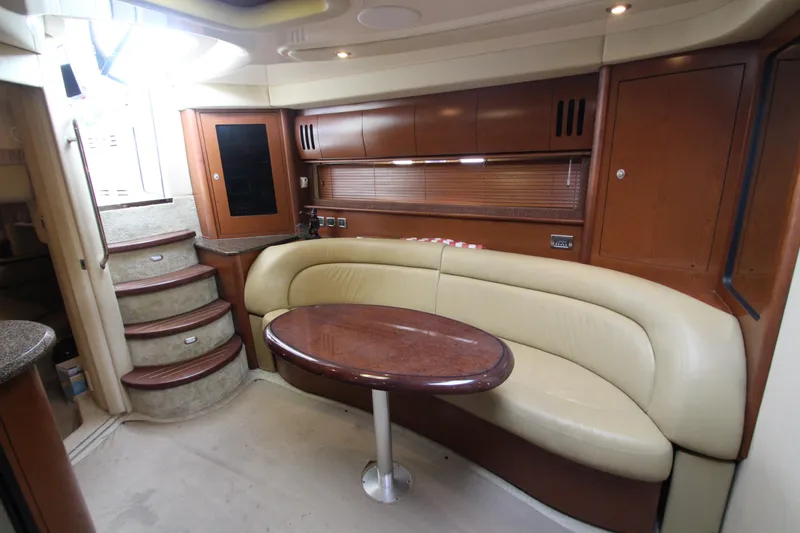 Slide: The Image of Interior of 2007 Sea Ray 44 Sundancer yacht with curved seating and wooden table. - 33