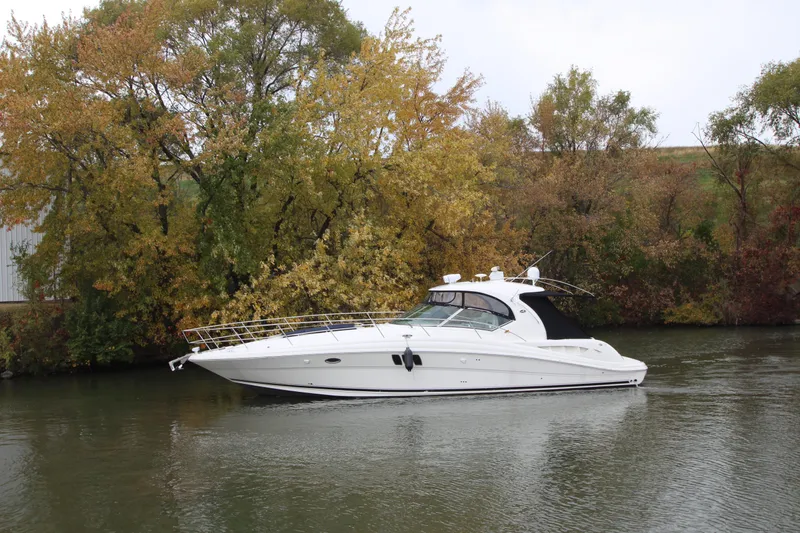 Slide: The Image of 2007 Sea Ray 44 Sundancer yacht cruising on a calm river with autumn trees. - 4