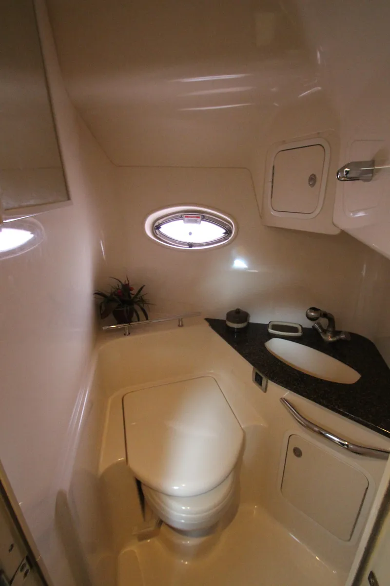 Slide: The Image of 2007 Sea Ray 44 Sundancer yacht bathroom with modern fixtures and porthole window. - 47