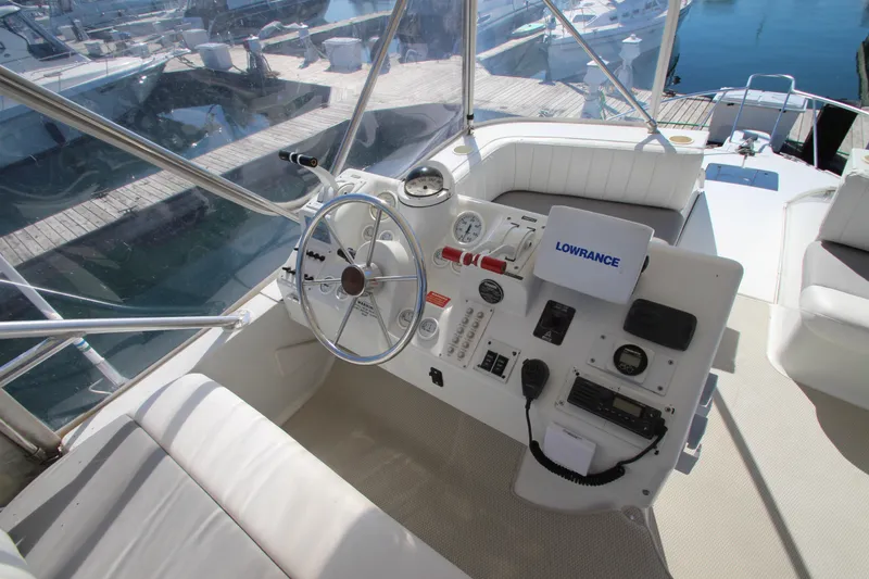 Slide: The Image of 1995 Mainship 31 Sedan Bridge helm with steering wheel and navigation equipment. - 17