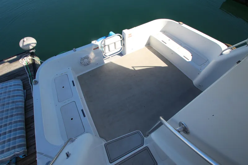 Slide: The Image of Spacious deck of 1995 Mainship 31 Sedan Bridge, featuring clean design and ample seating. - 18