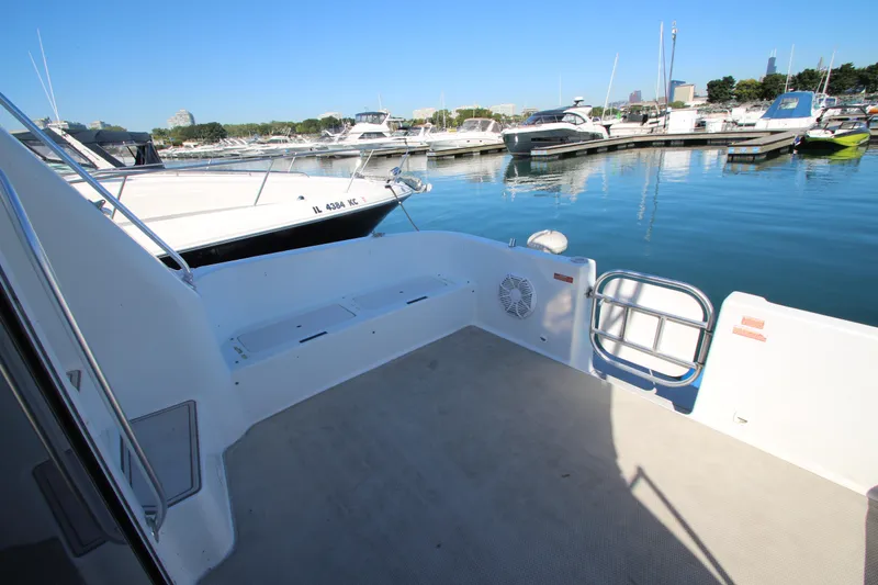 Slide: The Image of 1995 Mainship 31 Sedan Bridge at marina, spacious deck view. - 20