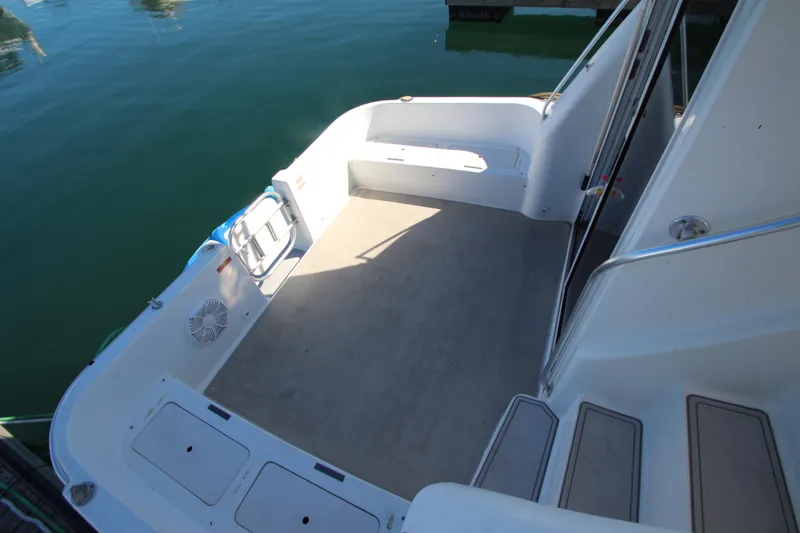 Slide: The Image of 1995 Mainship 31 Sedan Bridge boat deck with seating and storage. - 21