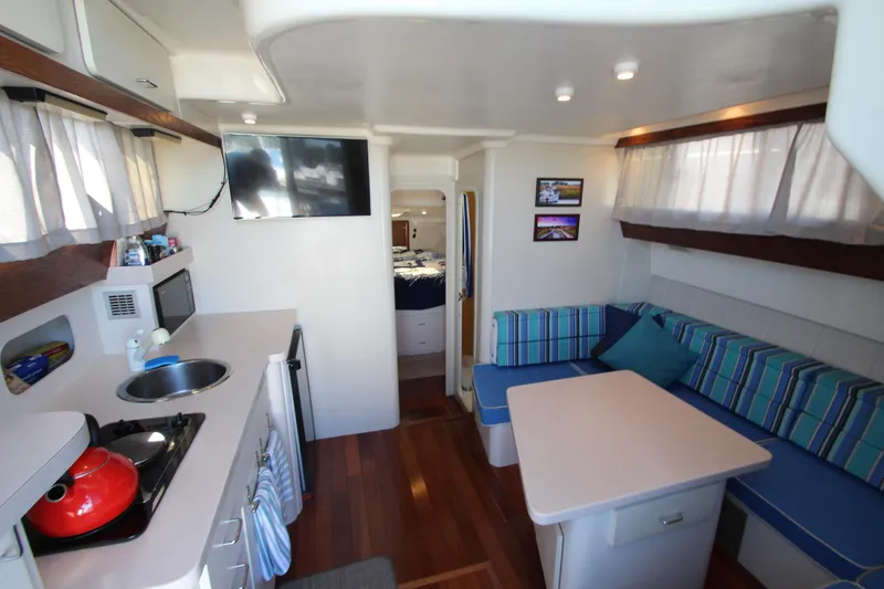 Slide: The Image of Interior of 1995 Mainship 31 Sedan Bridge with kitchenette and seating area. - 27