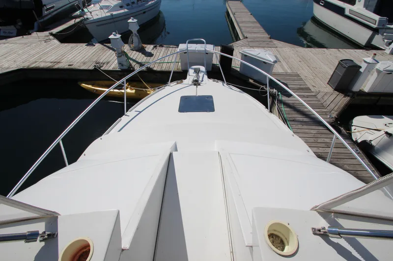 Slide: The Image of 1995 Mainship 31 Sedan Bridge docked at marina, top deck view. - 7