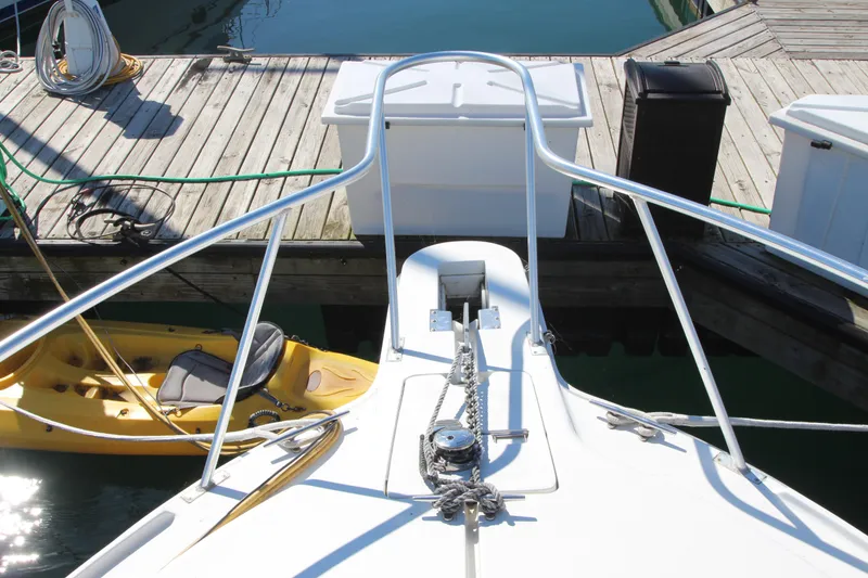 Slide: The Image of 1995 Mainship 31 Sedan Bridge bow with docked yellow kayak. - 8