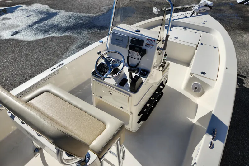 Slide: The Image of 2014 Pathfinder 2200 TRS boat interior with steering console and seating. - 10