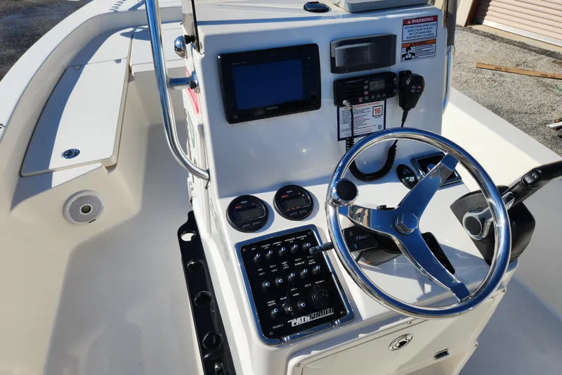 Slide: The Image of 2014 Pathfinder 2200 TRS boat console with steering wheel and navigation controls. - 12