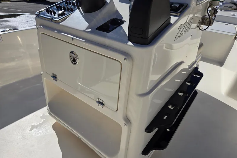Slide: The Image of 2014 Pathfinder 2200 TRS boat console with storage compartment and control panel. - 14