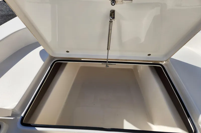Slide: The Image of Open storage compartment on a 2014 Pathfinder 2200 TRS boat. - 18