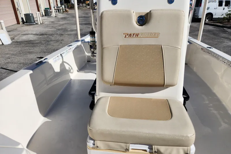 Slide: The Image of 2014 Pathfinder 2200 TRS boat interior with beige seating in a storage area. - 21