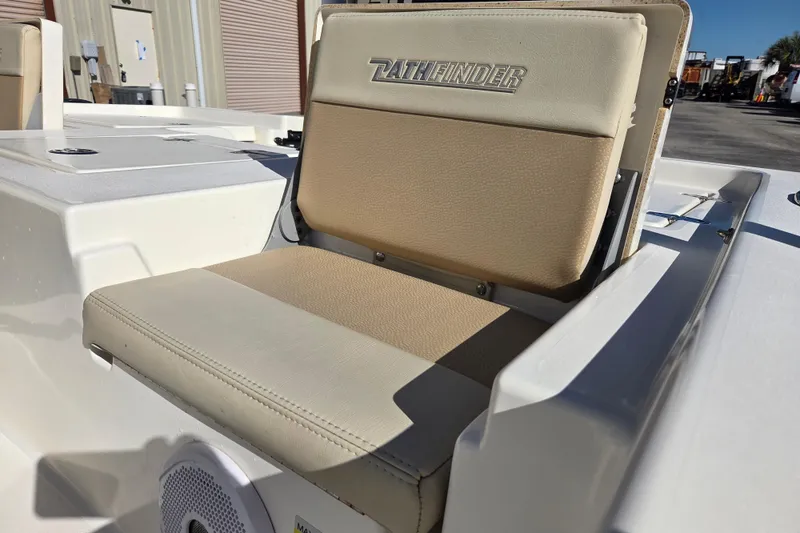 Slide: The Image of 2014 Pathfinder 2200 TRS boat seat with logo, beige upholstery, and speaker detail. - 27