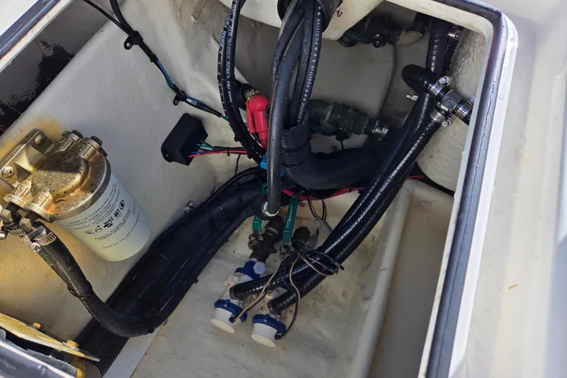 Slide: The Image of 2014 Pathfinder 2200 TRS boat wiring and fuel filter system in compartment. - 29