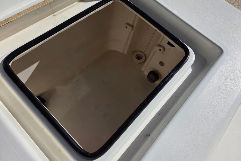 Slide: The Image of Open storage compartment on 2014 Pathfinder 2200 TRS boat, showing interior details. - 30