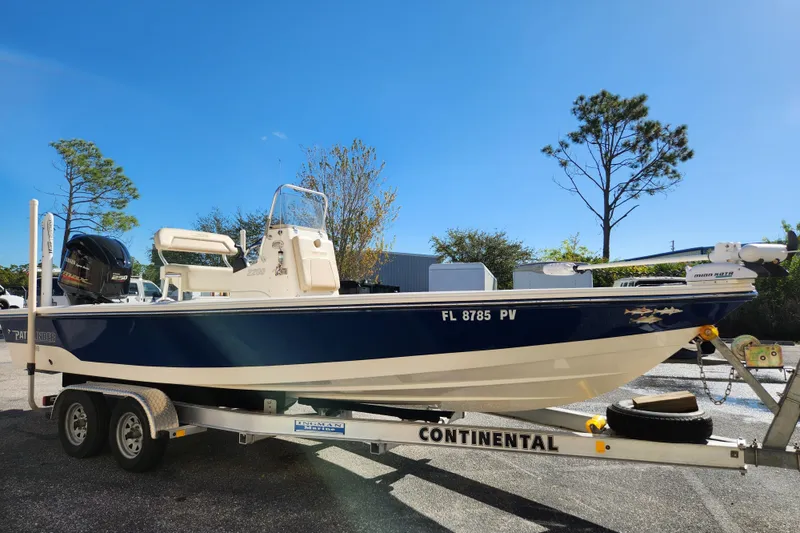 Slide: The Image of 2014 Pathfinder 2200 TRS boat on Continental trailer under clear blue sky. - 4