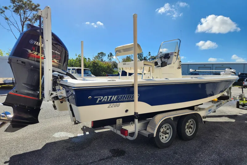 Slide: The Image of 2014 Pathfinder 2200 TRS boat on trailer with Yamaha outboard motor, sunny day. - 5