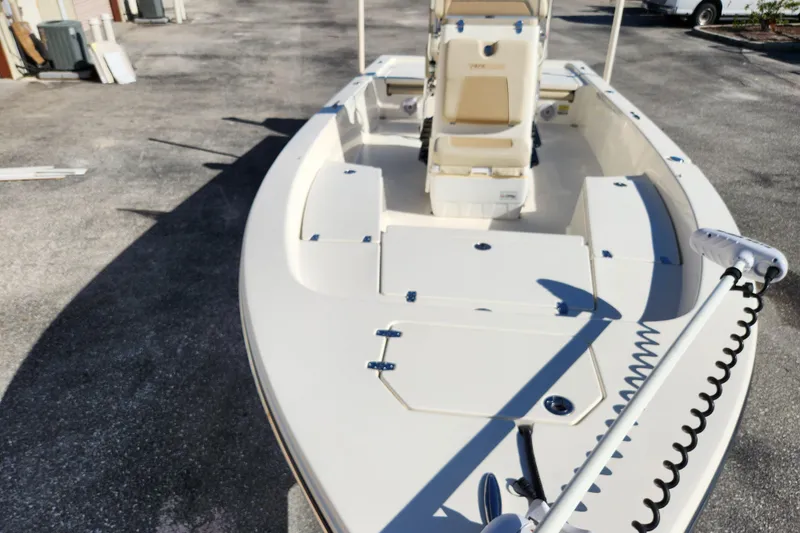 Slide: The Image of 2014 Pathfinder 2200 TRS boat, white deck, parked on concrete surface. - 7