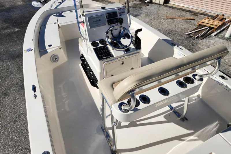 Slide: The Image of 2014 Pathfinder 2200 TRS boat interior with steering console and seating. - 9