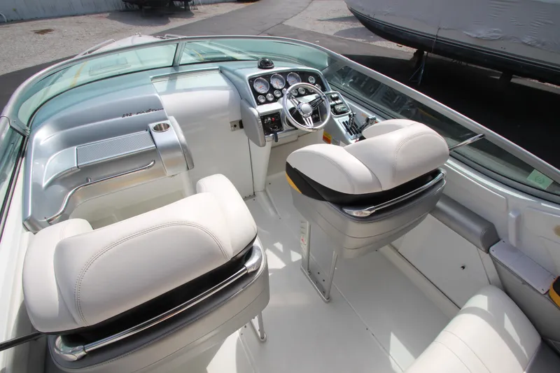 Slide: The Image of 2008 Formula 292 FASTech boat interior with steering wheel and white seating. - 12